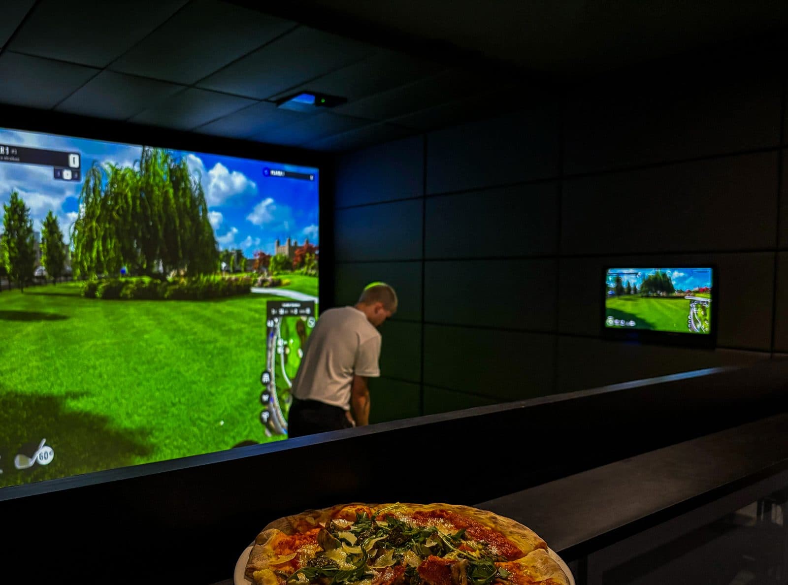 A member playing a round with pizza served at the bay